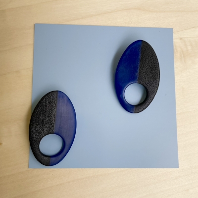 handmade half black, half translucent blue oval polymer clay earrings with stainless steel posts