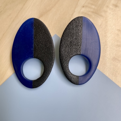 handmade half black, half translucent blue oval polymer clay earrings with stainless steel posts