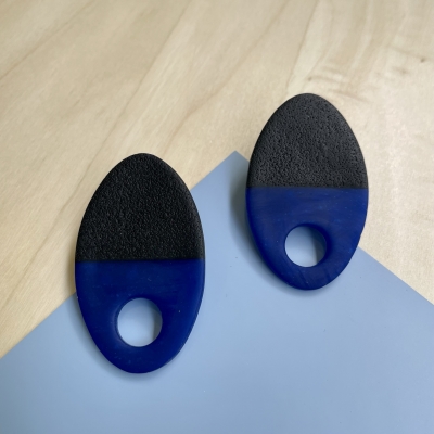 handmade half black, half translucent blue oval polymer clay earrings with stainless steel backs