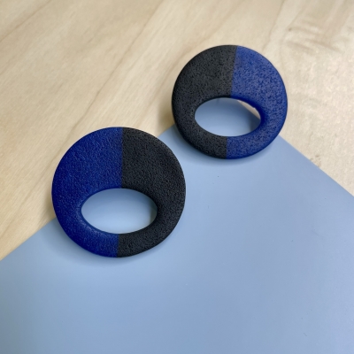 handmade half black, half translucent blue abstract circle polymer clay earrings with stainless steel backs