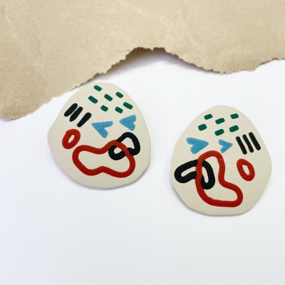 abstract handmade polymer clay earrings with colorfull art line and beige background