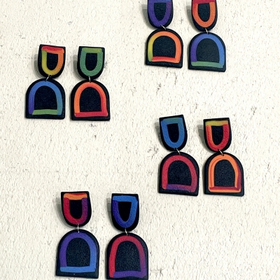 Black handcrafted polymer clayk earrings with colourful lines 