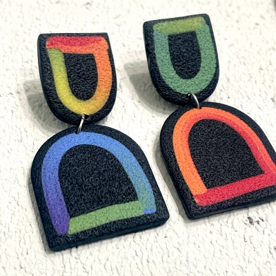 Black handcrafted polymer clayk earrings with colourful lines 