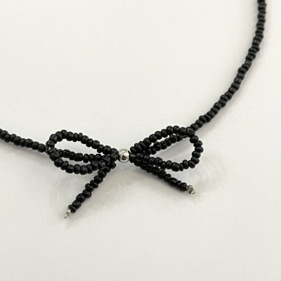 Handmade necklace from beads with bead bow
