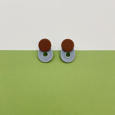 Polymer clay earrings with brown little circle and light blue stripes