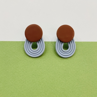Polymer clay earrings with brown little circle and light blue stripes